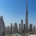 Dubai skyline featuring the Burj Khalifa and Downtown Dubai under a clear blue sky.
